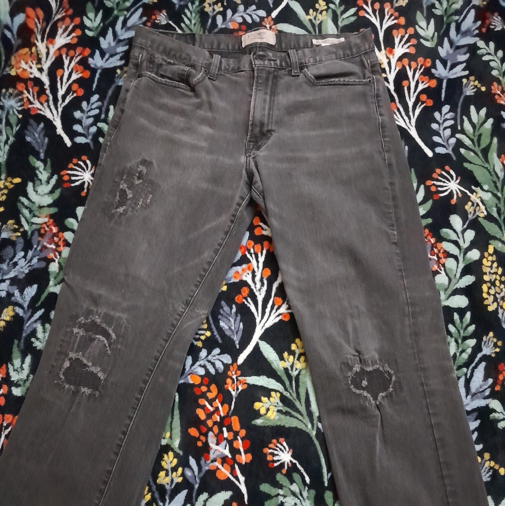 A pair of washed ripped black jeans